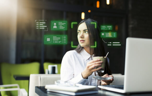 Businesswoman working on a laptop with core HR software interface displaying employee data