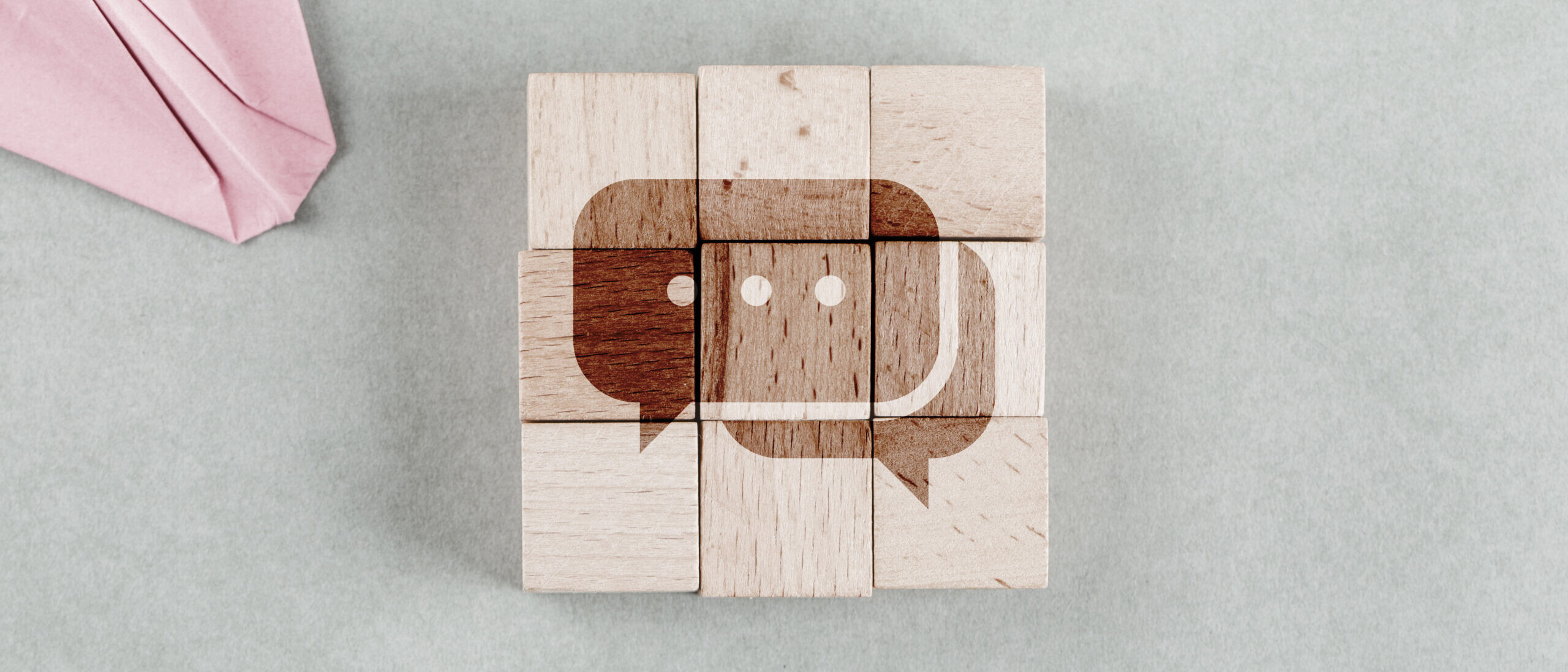 Wooden blocks forming a chat icon representing the best internal communication tools