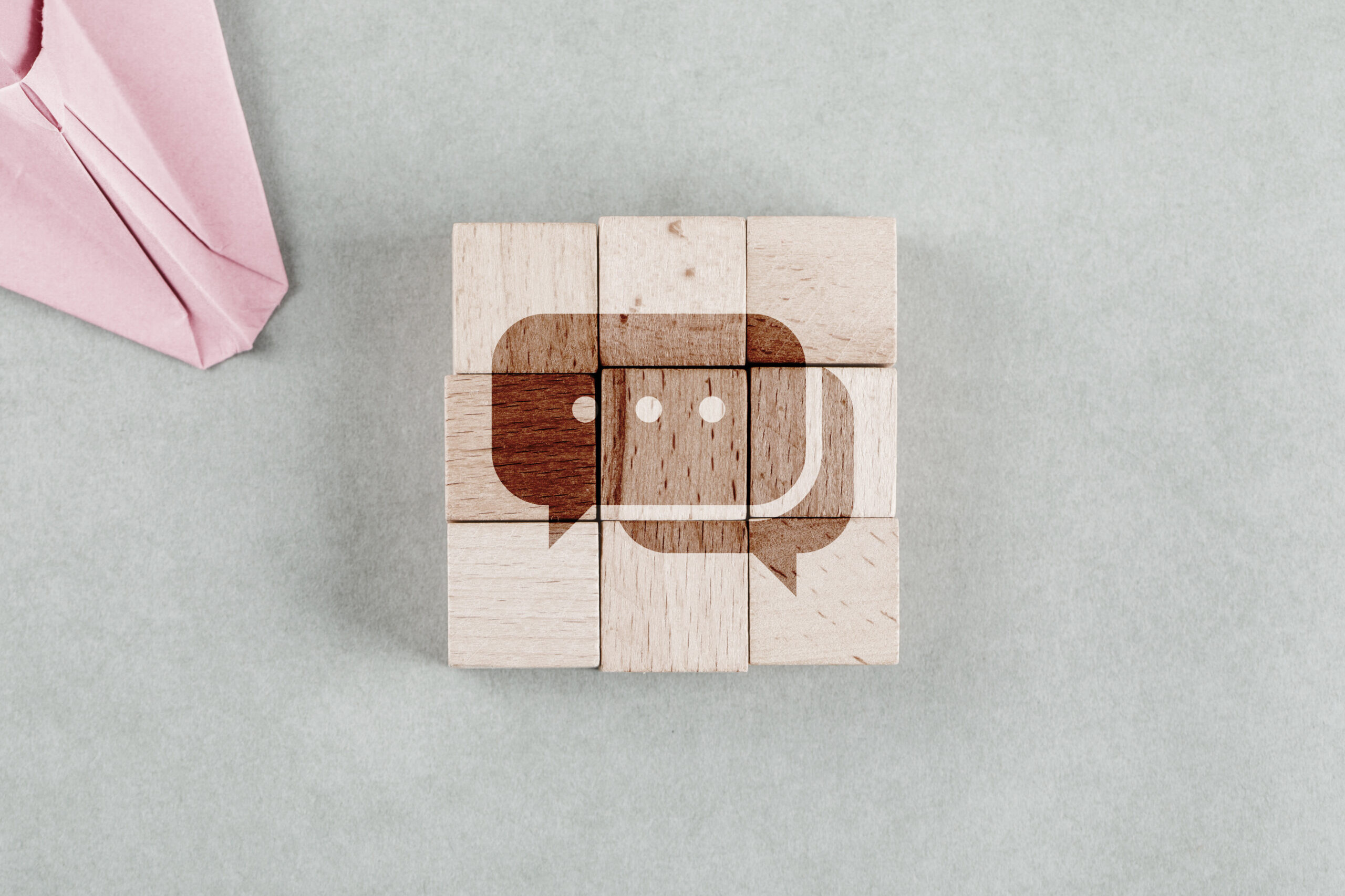 Wooden blocks forming a chat icon representing the best internal communication tools