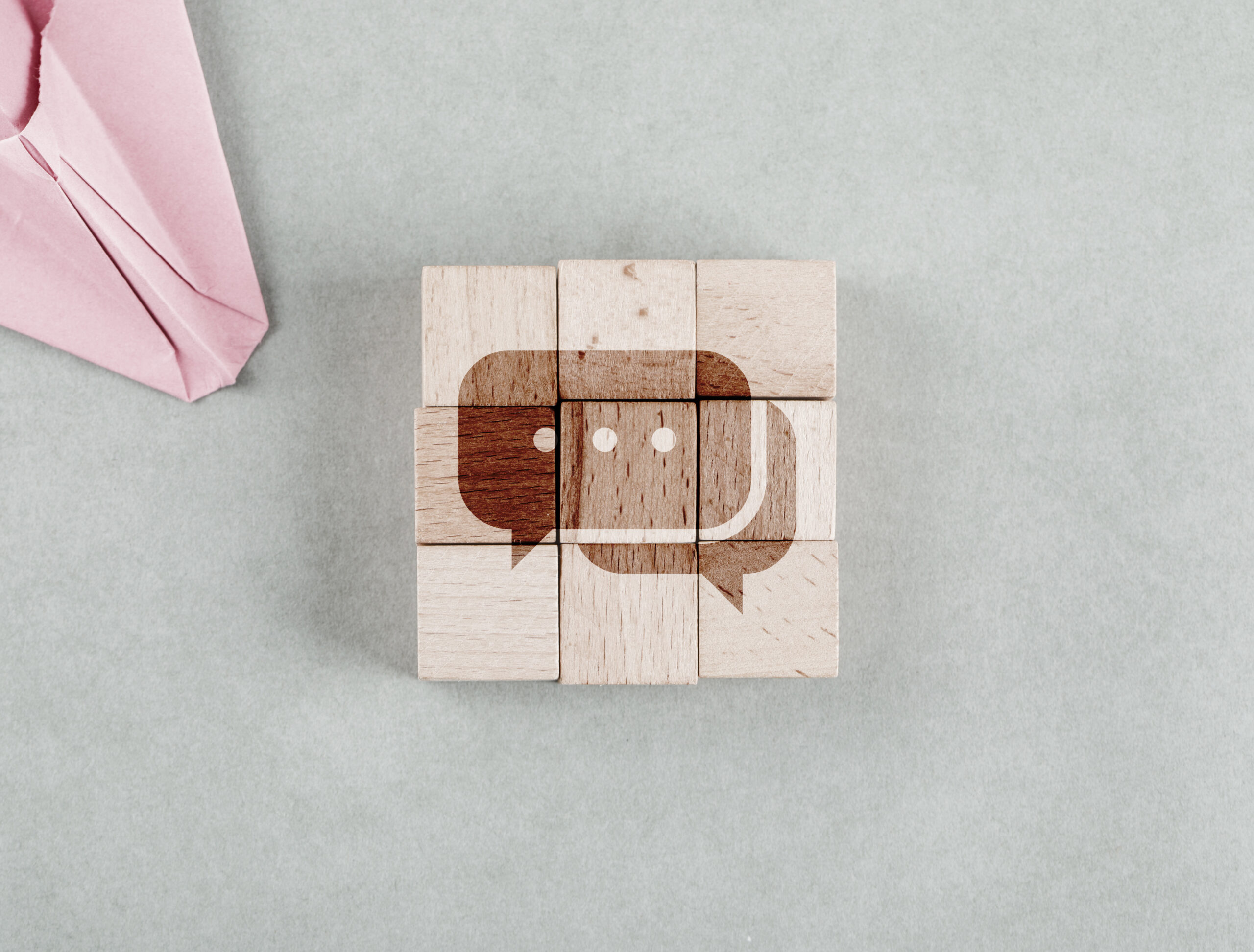 Wooden blocks forming a chat icon representing the best internal communication tools