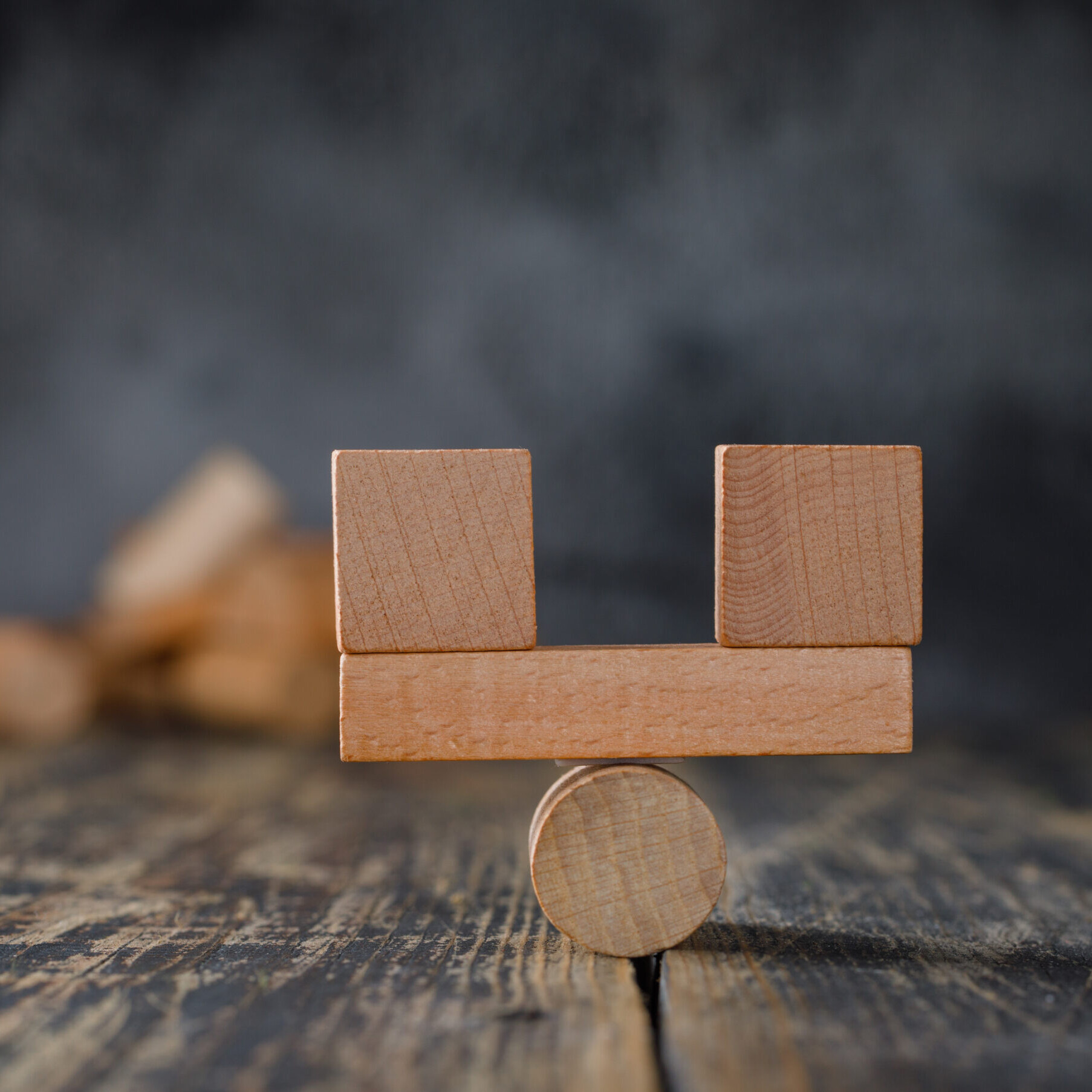 Deel vs Rippling comparison concept with balanced wooden blocks on a scale