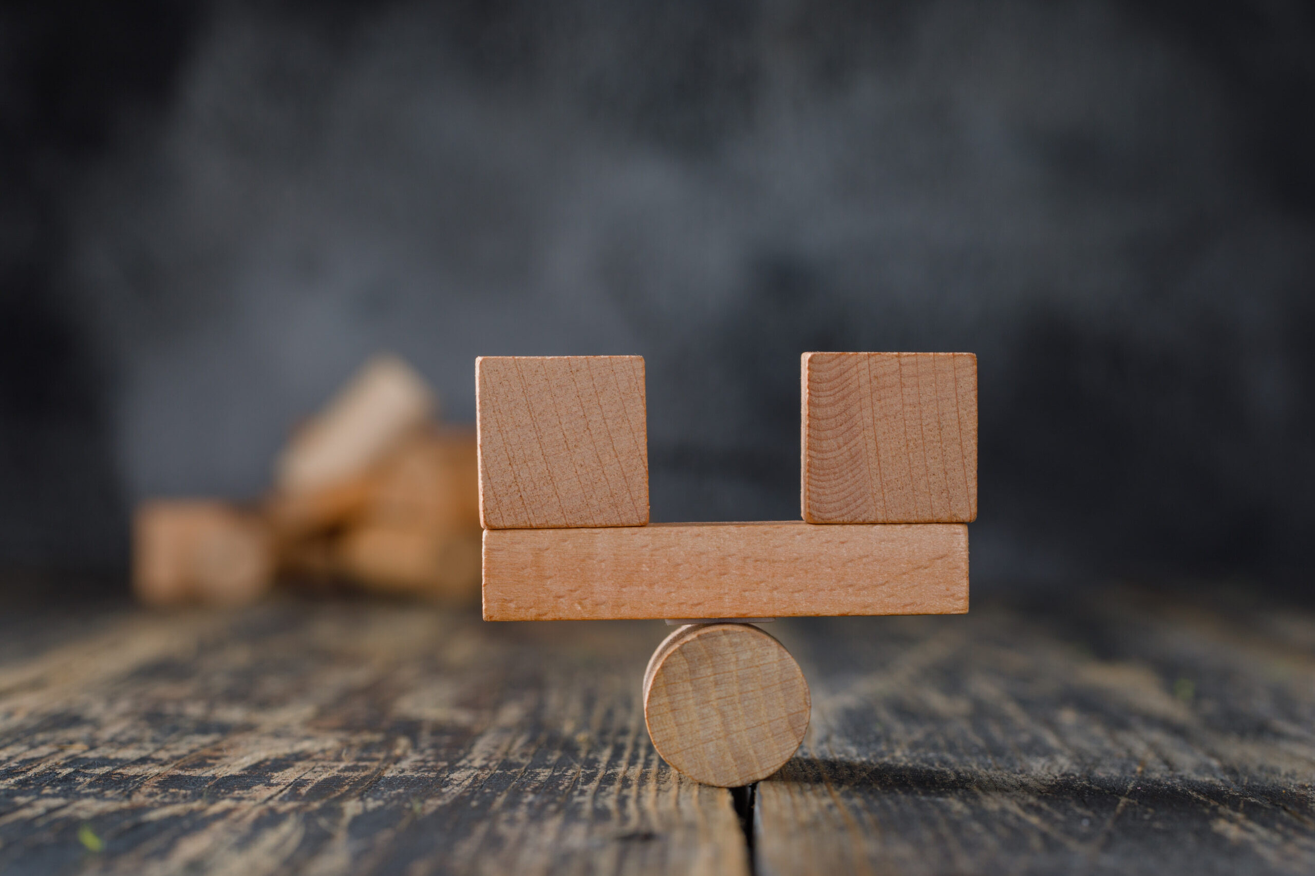 Deel vs Rippling comparison concept with balanced wooden blocks on a scale